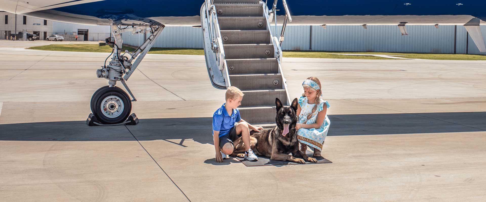 Belgian Malinois with family by private plane